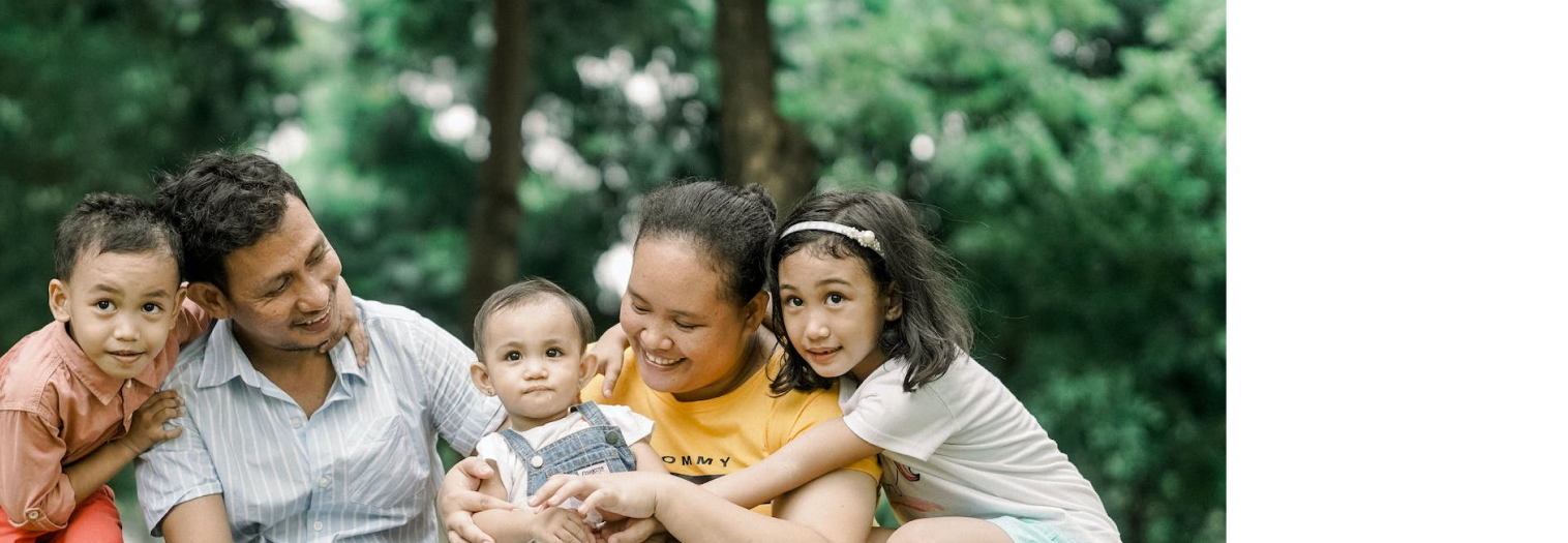 a family of five in front of a forest